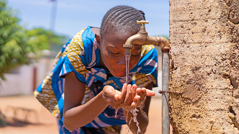 Candid picture of African Black Girl Drinking Water in Bamako Mali